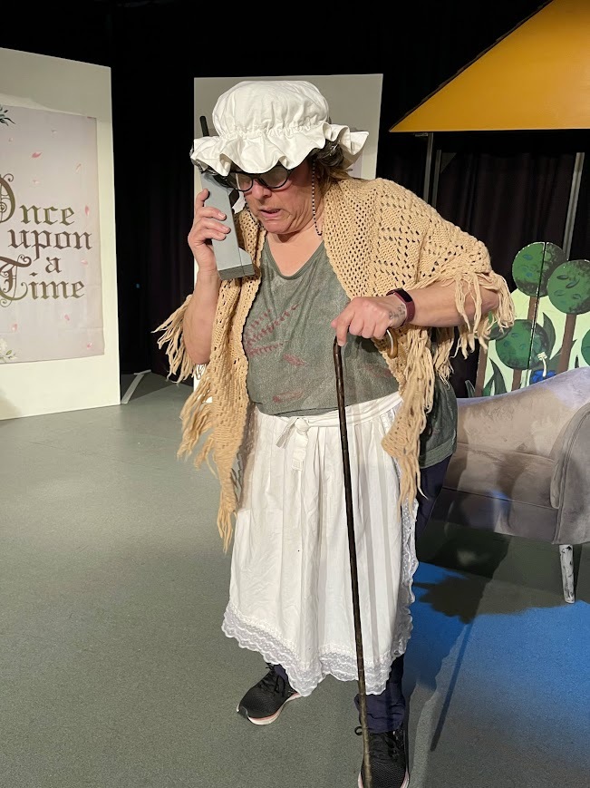 Sally playing the grandma from 'Little Red Riding Hood' (referred to in the play as 'Little Red Riding Cap').
